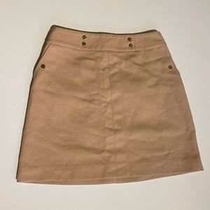 Tan mini skirt with gold accents ( buttons and zipper)